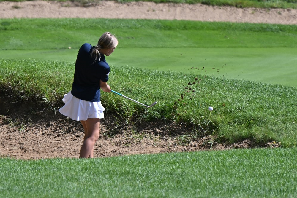 An Otsego golfer sends her ball out of a sand trap during a match against Plainwell.