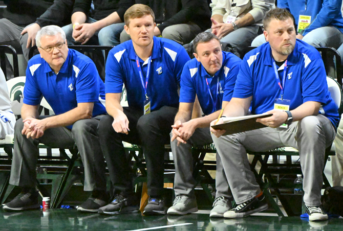 Tri-unity’s assistant coaches, including Holzwarth (second from right), monitor the action.