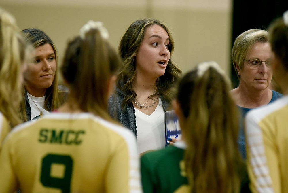 Cassie Haut, middle, talks with her Monroe St. Mary Catholic Central team last season as co-varsity coach with Karen O’Brien, right. 