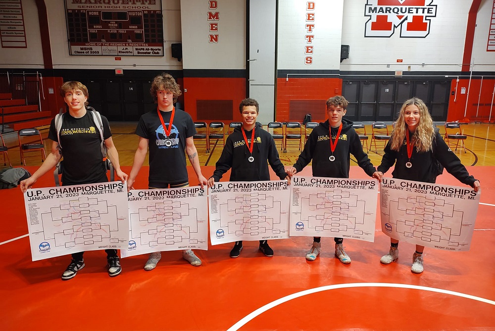 Iron Mountain’s winners at the U.P. Championships at Marquette hold up their charts, from left: Evan Haferkorn, Fulton Stroud, Shawn McGuire, Alex Wilson and Shayna Hruska.