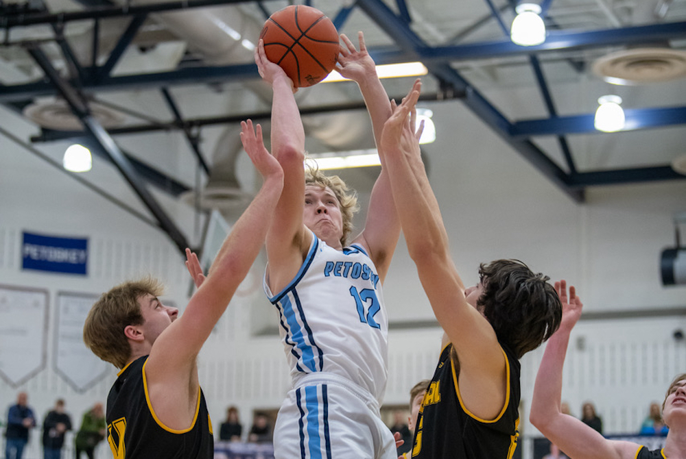 Petoskey’s Michael Squires rises above a pair of Traverse City Central defenders for a shot.