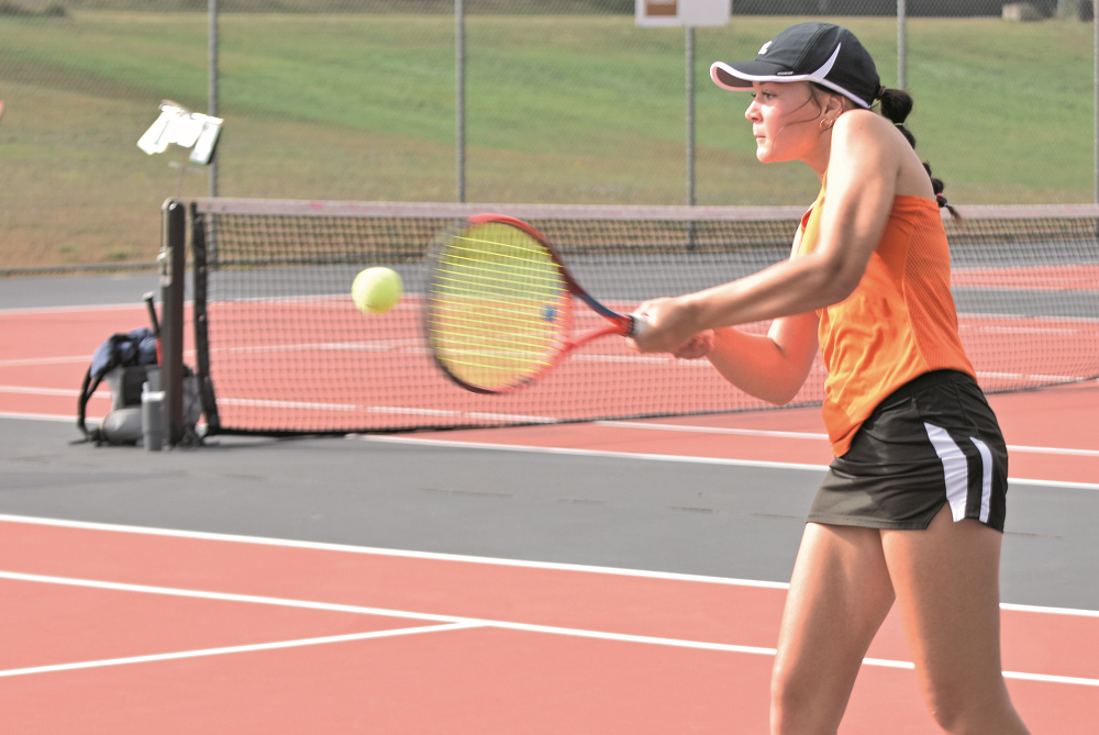 Escanaba senior Sophie Derkos returns a volley during her semifinal match with Gladstone’s Tia Schone on Wednesday. 