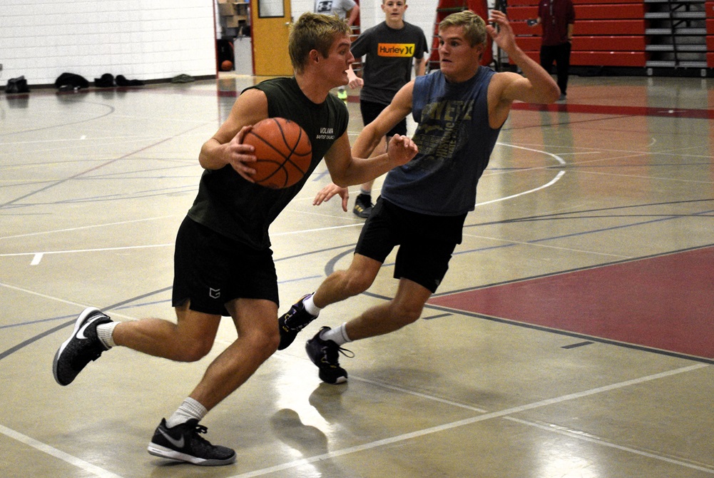 Colin Muldoon drives to the basket against his twin brother Dylan Muldoon during recent Howardsville Christian boys basketball practice. 