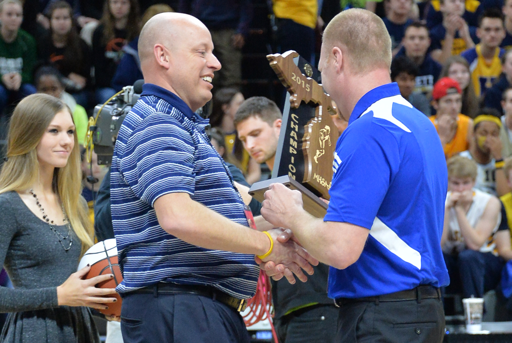 Calumet athletic director Sean Jacques, second from left, presents the Class C championship trophy to Copper Kings coach Jeff Twardzik in 2015.