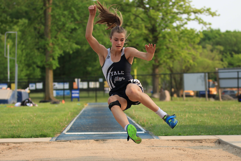 Yale’s Sadie Dykstra launches into a long jump last spring.