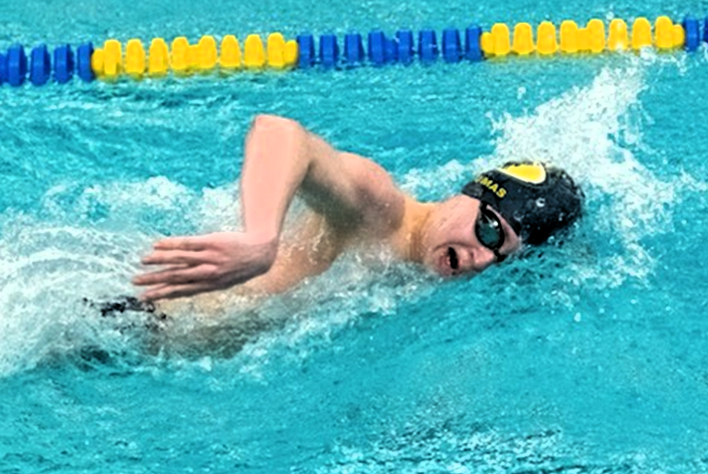Aaron Thomas races for the DeWitt swimming & diving team.