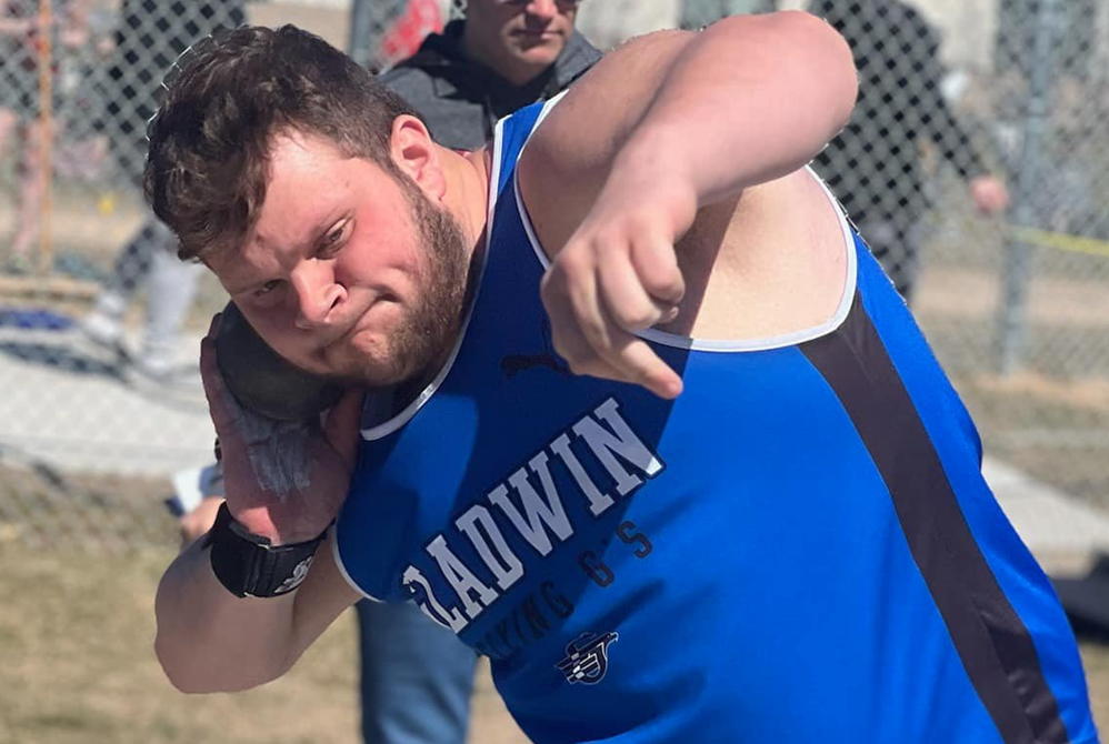 Gladwin’s Logan Klein prepares to launch during a turn in the shot put circle.