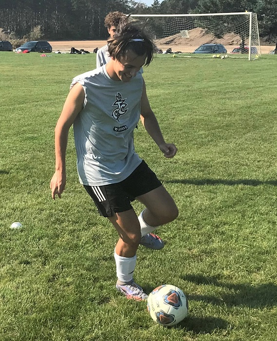 Henry Reineck kicks the ball around during a Traverse City Christian practice. 