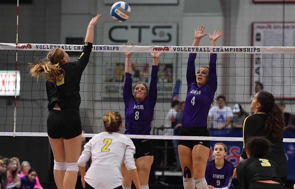 Athens’ Kamryn Parlin (4) and Alaina Brubaker (8) put up a block as Lansing Christian’s Anna Jackson (5) looks for an opening in the defense. Athens swept the Division 4 Semifinal 25-18, 25-20, 25-23.