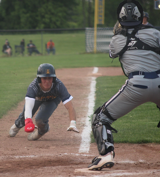 Matthew Rix slides into home as a throw comes in.