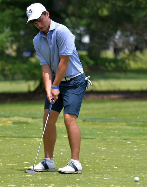 Teammate Will Preston putts; he finished second individually.