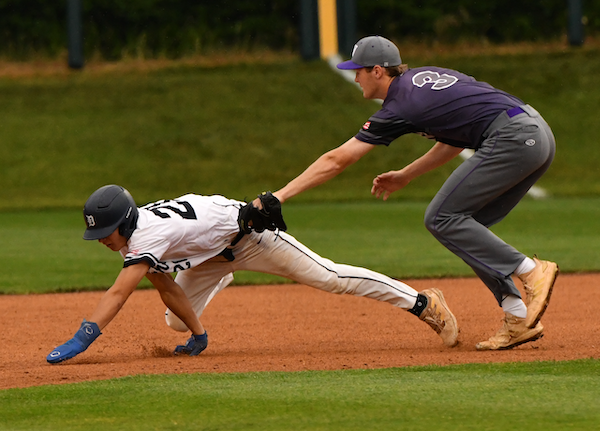 Woodhaven’s Evan Langlois (3) applies a tag during his team’s Semifinal win over Macomb Dakota.