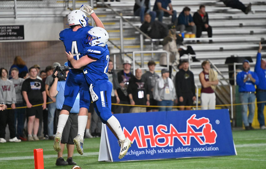 Inland Lakes’ Jacob Willey (4) and Avery Enos celebrate Willey’s second touchdown of the 8-Player Division 1 Final. 