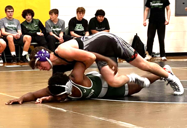 Vasquez works on gaining the advantage in a match against Mendon. 