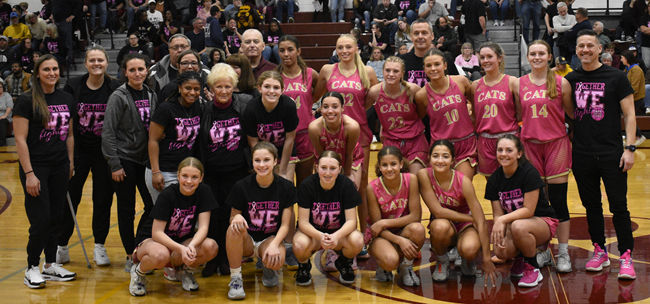 Niles Brandywine varsity girls' basketball team members and coaches pose for a photo during the Bobcats’ annual Pink Game on Cancer Awareness Night.
