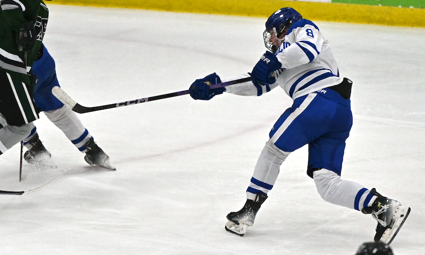 Detroit Catholic Central’s Cael Rogowski (8) sends a shot during his team’s Semifinal win over Muskegon Reeths-Puffer. Rogowski scored during the second period of the 8-0 victory.