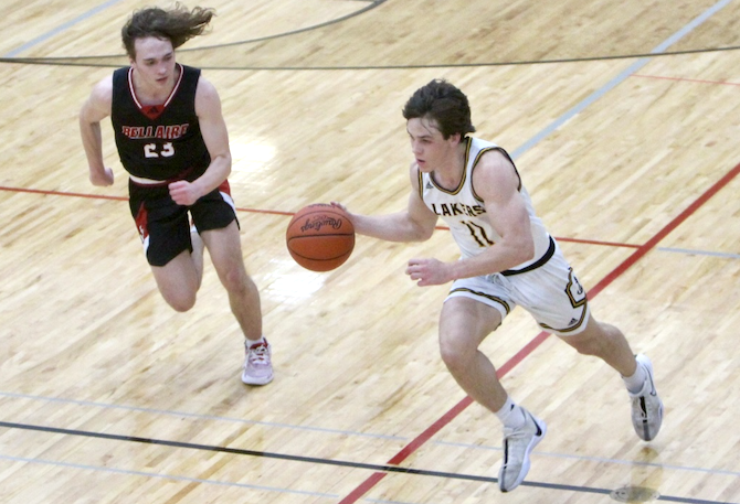 Glen Lake’s Cooper Bufalini (11) pushes the ball upcourt during a 65-49 District Final win over Bellaire.